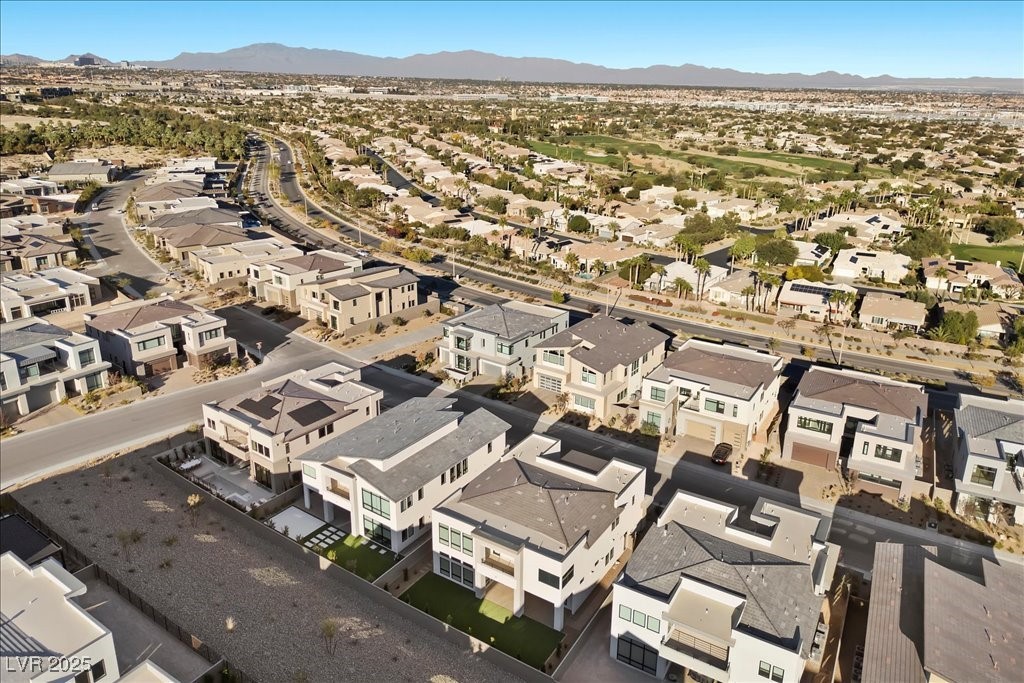 Aerial view of modern Las Vegas homes with distant mountains beyond the neighborhood.
