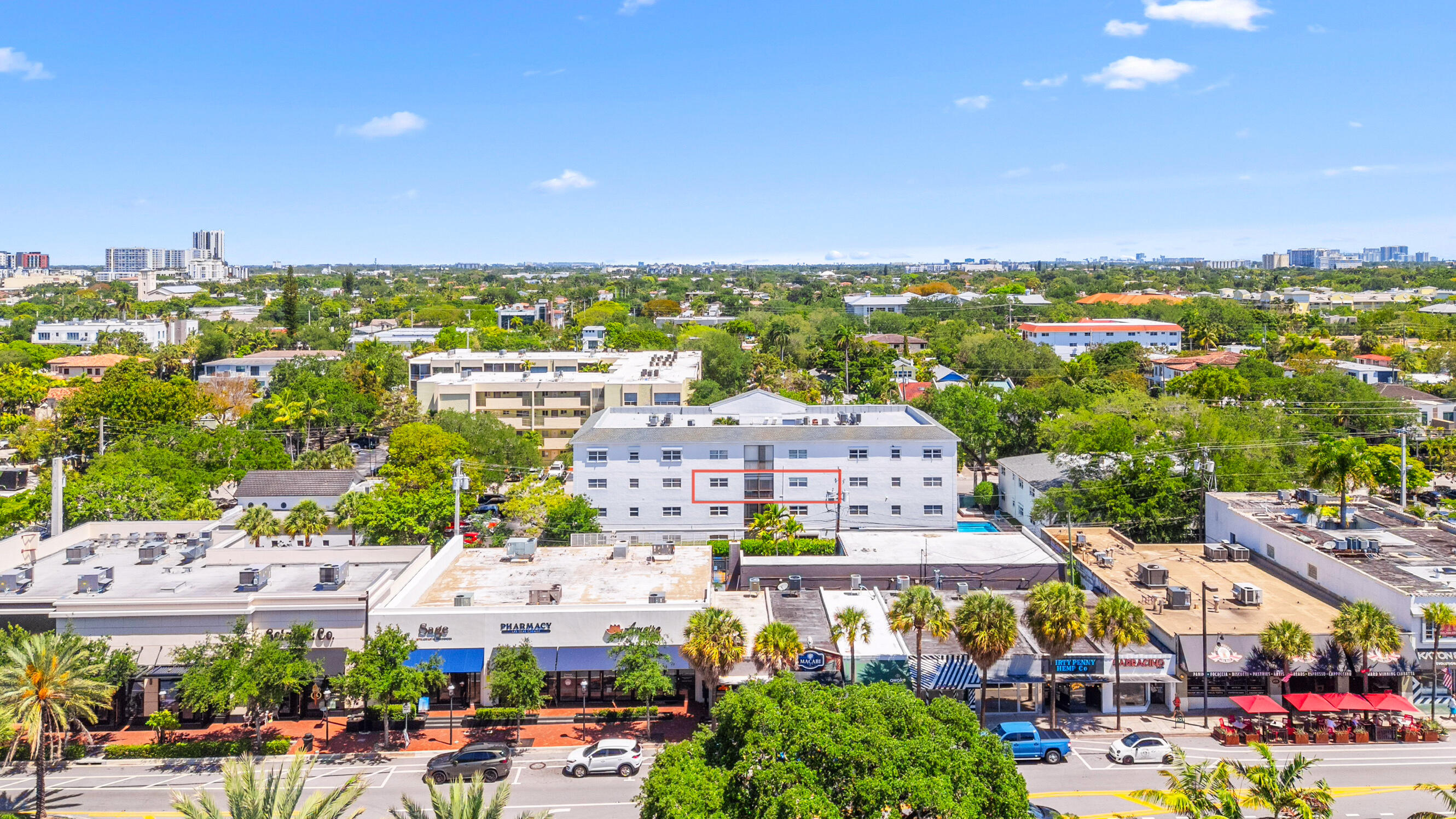 Aerial view of Fort Lauderdale shops and apartments, with a red outline highlighting part of a white mid-rise building.