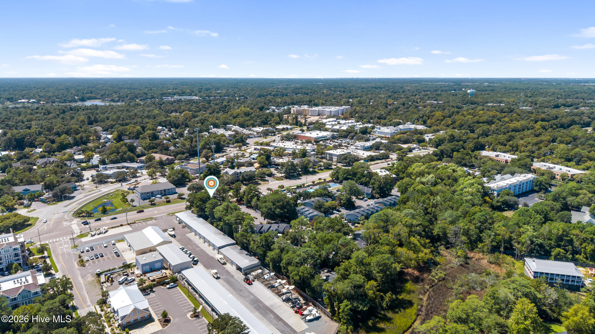 Aerial view of the wooded neighborhood, with a location marker near a major intersection.