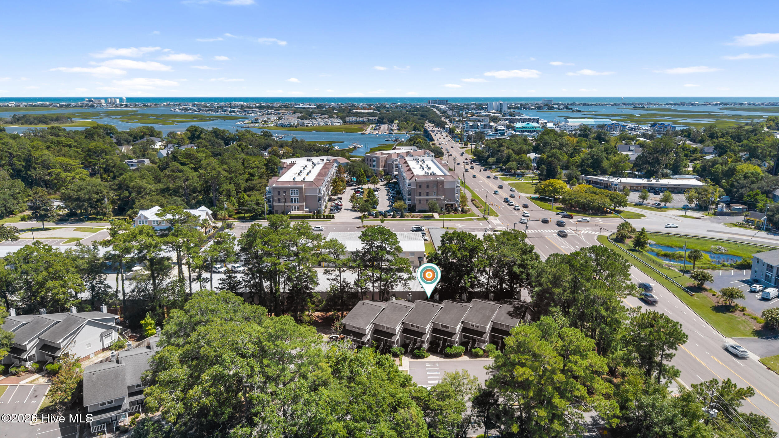 Aerial view of Eastwood Road townhomes, with a location marker and coastal waterways and ocean beyond.