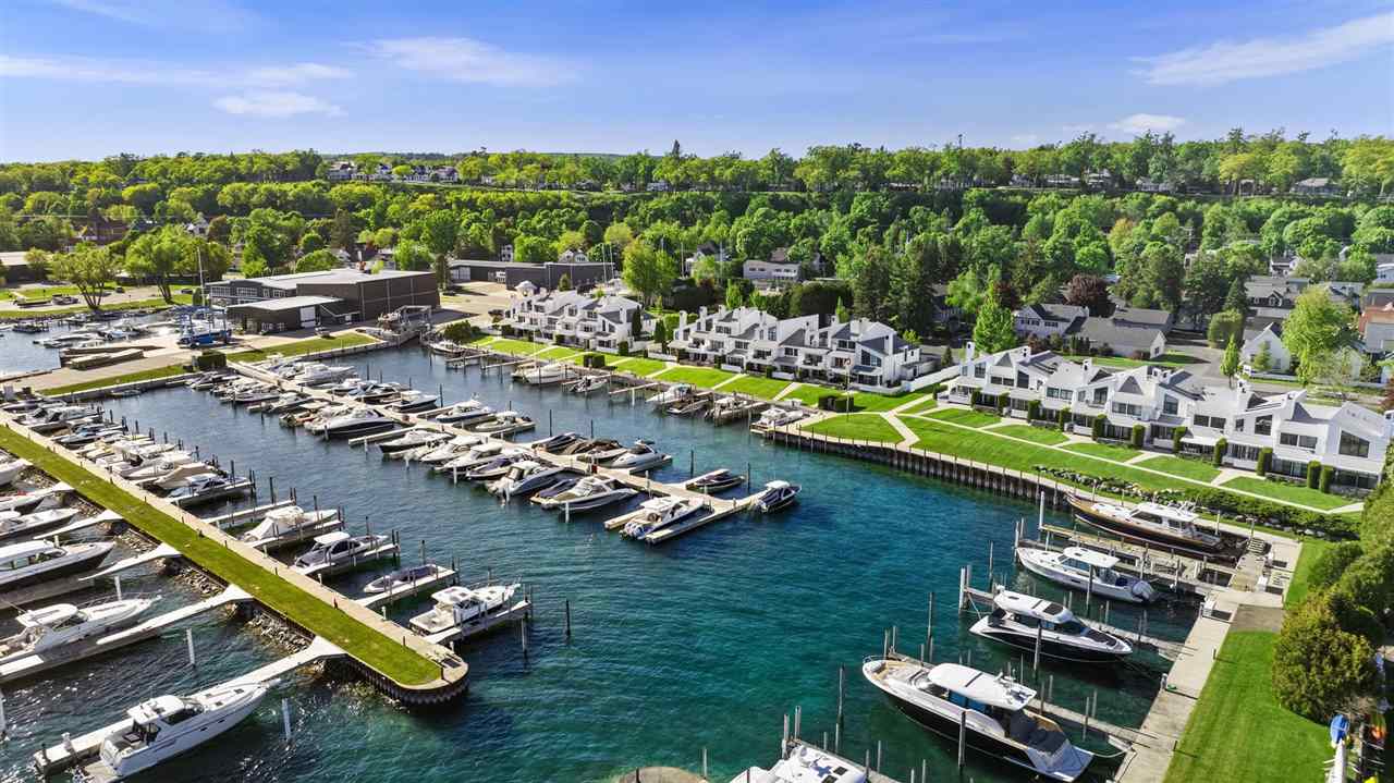 Waterfront homes and a marina filled with boats, seen from above.