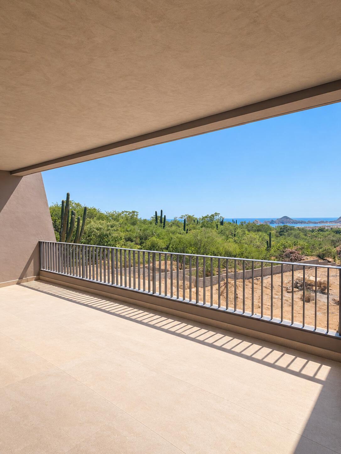 Covered tiled terrace overlooking cactus-covered hills and the sea.