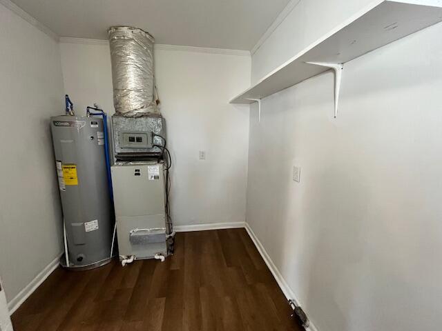 Utility room with a water heater, HVAC furnace, high shelf, and dark wood-look flooring.