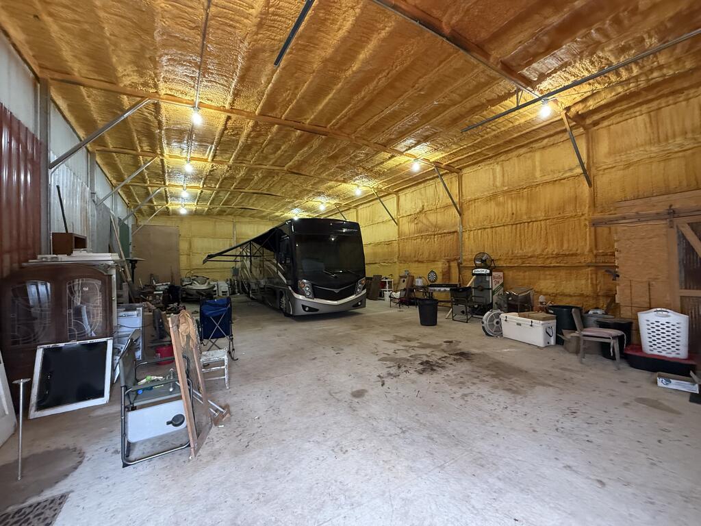 Large insulated garage with a motorhome and stored equipment.