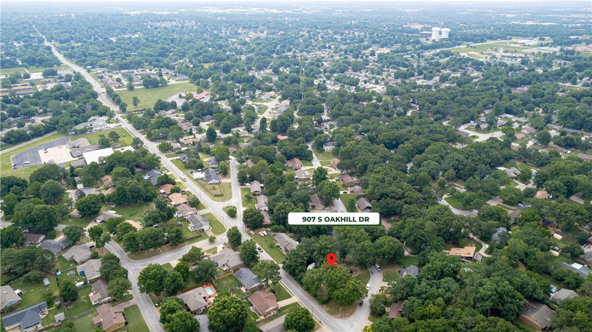 Aerial view of a leafy neighborhood, with 907 S Oakhill Drive marked by a red pin.