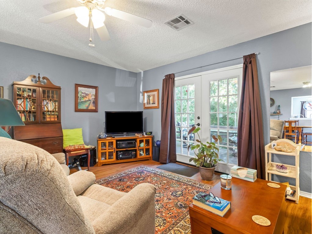 Furnished living room with a patterned rug and sliding glass doors to the patio.