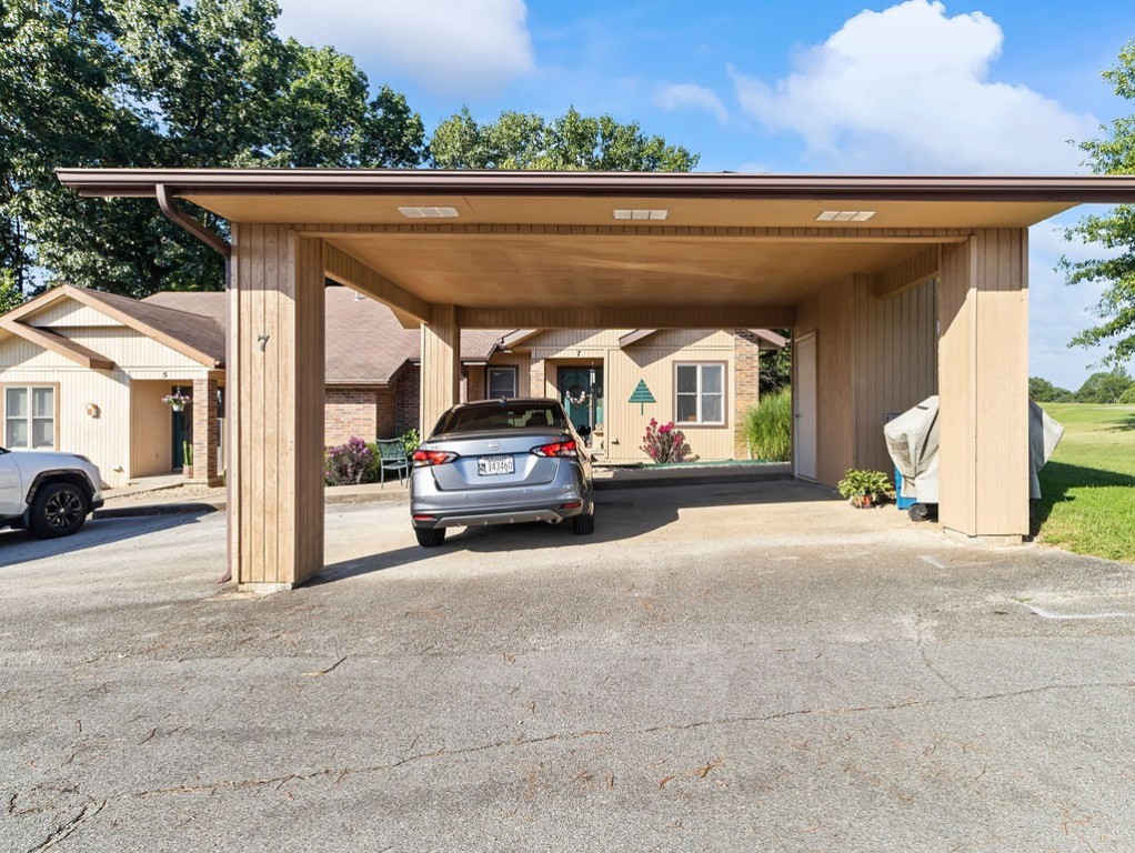 Single-story home with a wide covered carport and paved driveway.