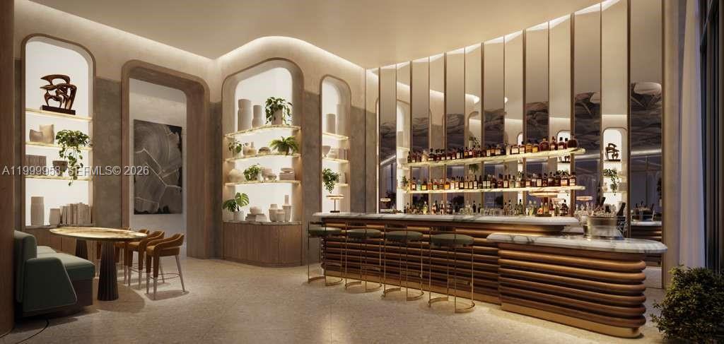 Interior lounge with a curved bar, mirrored wall, and nearby dining table.