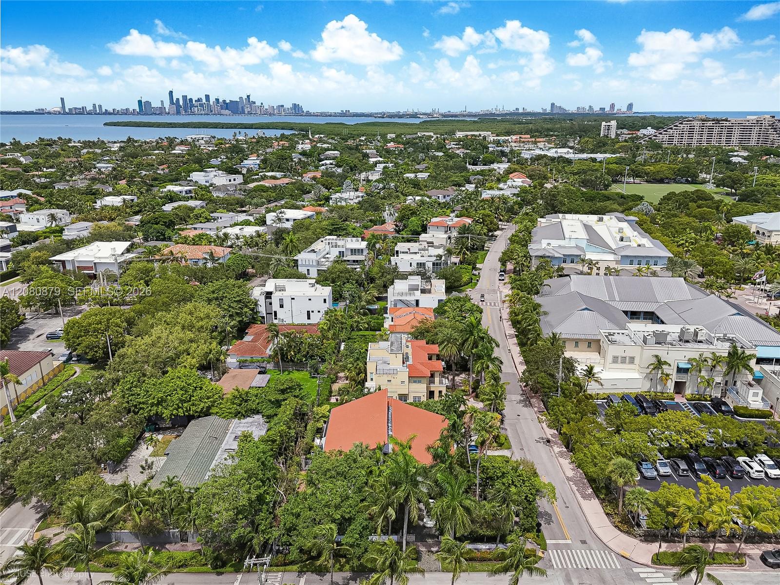 Aerial view of Key Biscayne homes, Biscayne Bay, and the distant Miami skyline.