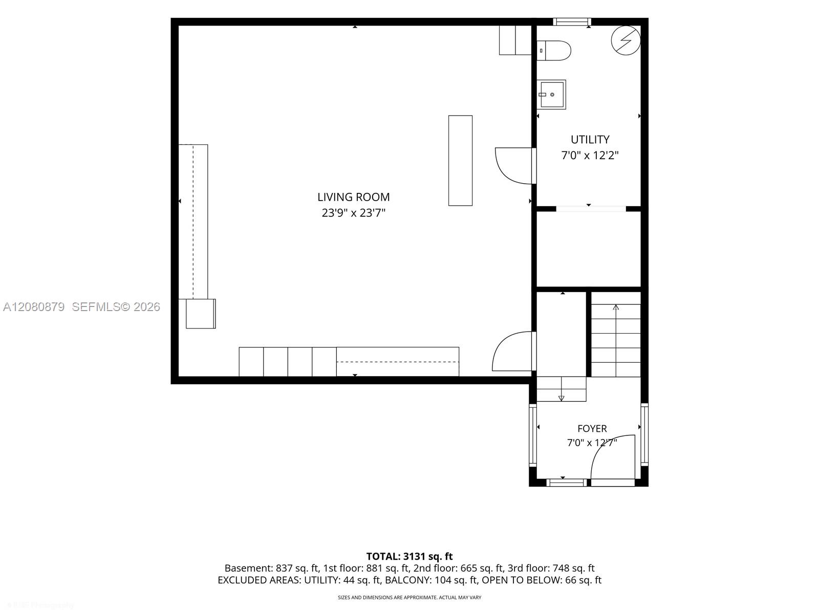 Floor plan showing a large living room, utility room, foyer and stairways.