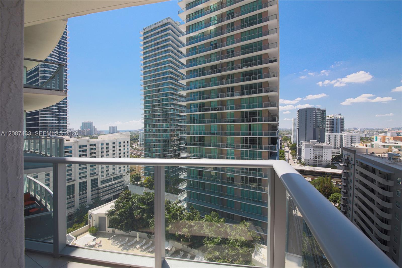 Miami condo balcony overlooking neighboring high-rises and the city skyline