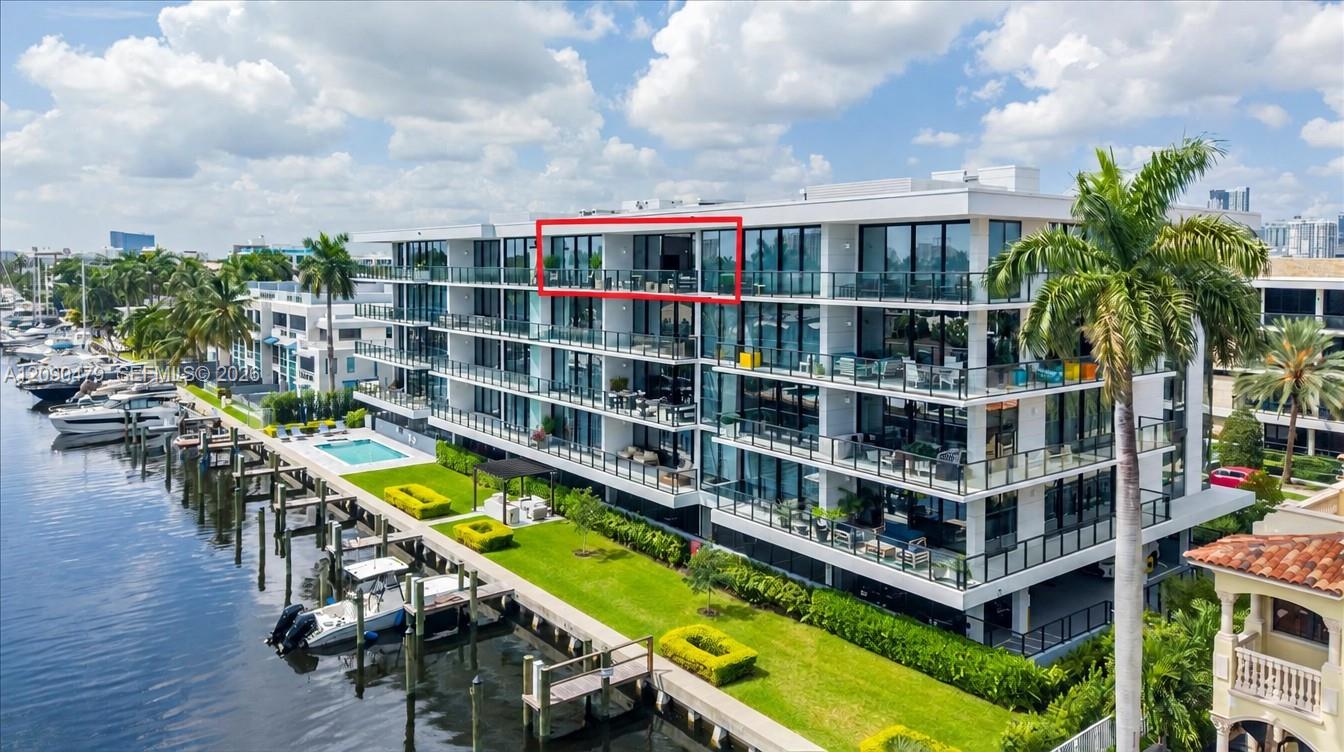 Waterfront condominium viewed from above, with the penthouse balcony outlined in red.