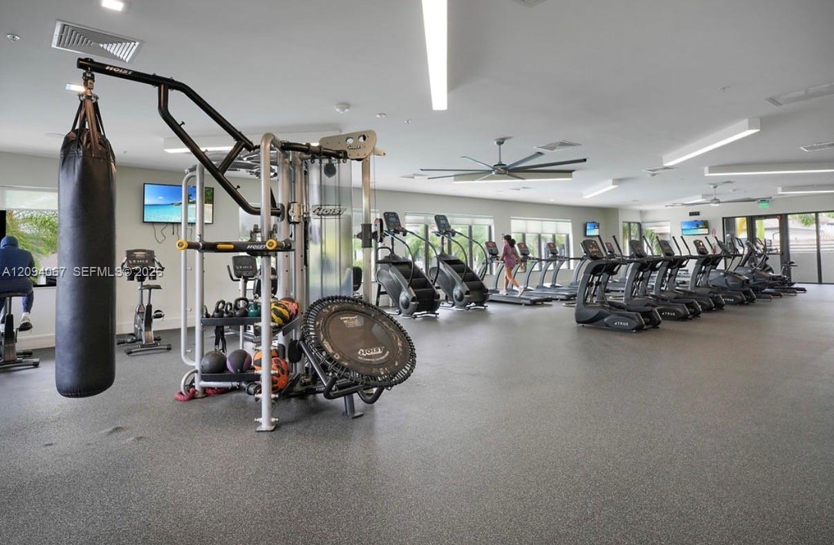 Fitness center with treadmills, weight machines, and a hanging punching bag.
