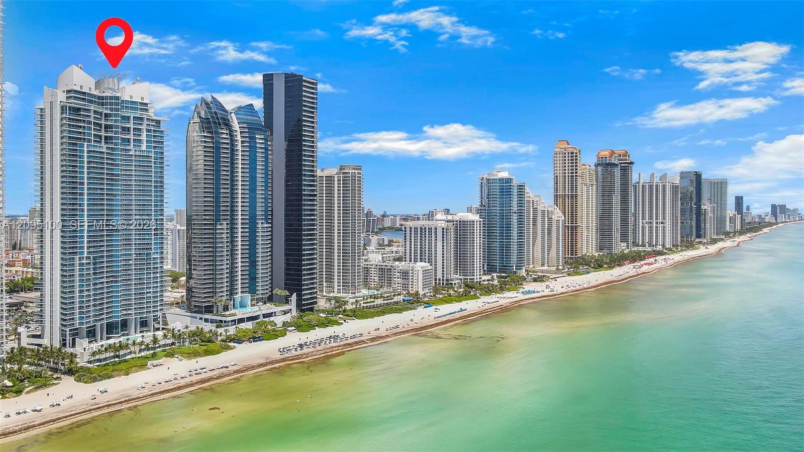 Sunny Isles Beach high-rises along the turquoise shoreline, with a red pin marking one tower.