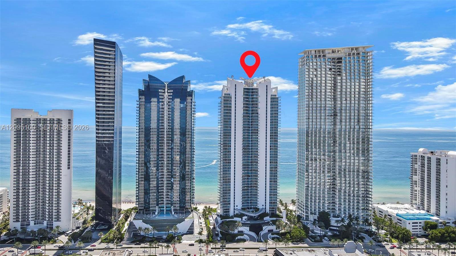 Oceanfront condominium towers in Sunny Isles Beach, with a white high-rise marked by a red pin.