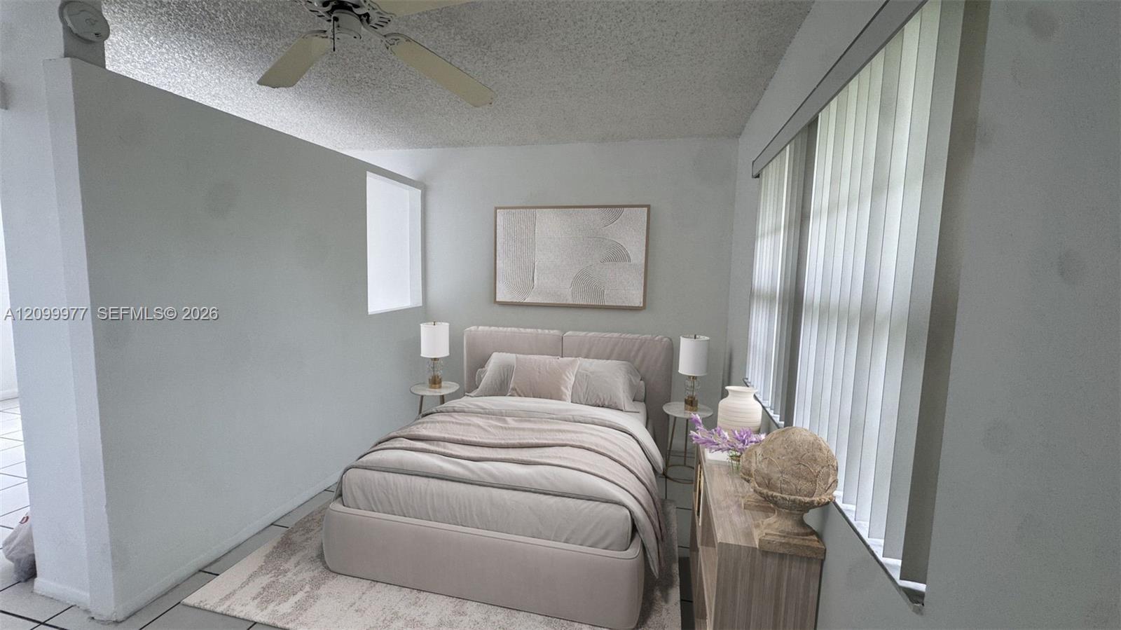 Staged bedroom with a neutral upholstered bed, abstract wall art, and tall windows with vertical blinds.
