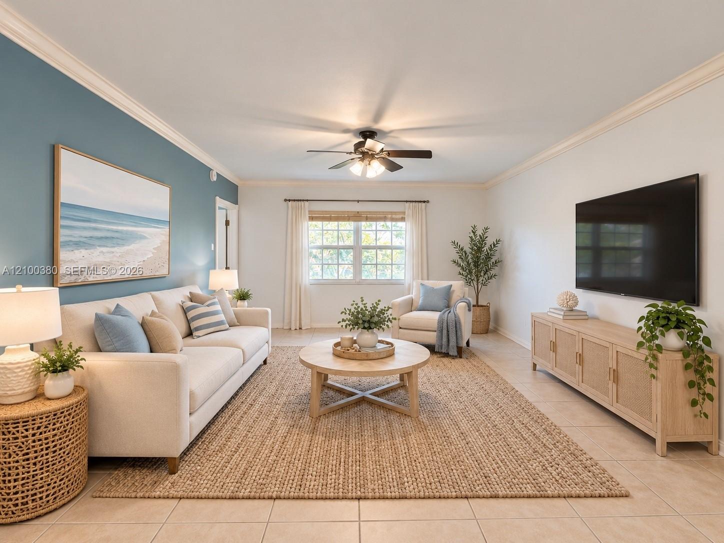 Furnished living room with a white sofa, blue accent wall, and large woven rug.