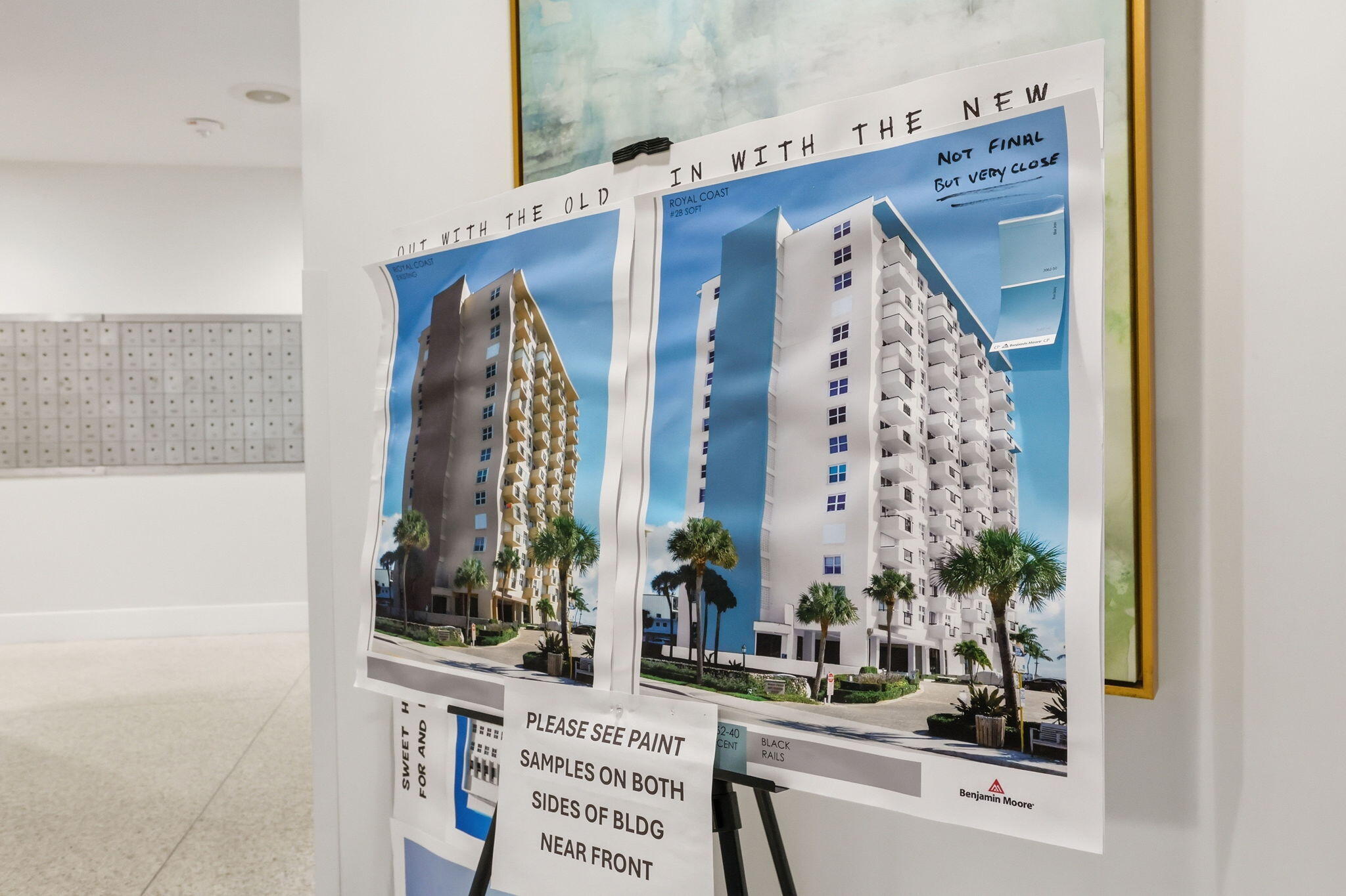Condominium lobby display comparing the old facade with a proposed white exterior and balconies.
