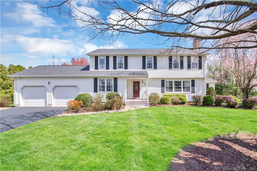 White two-story colonial home with black shutters, red front door, and attached two-car garage.