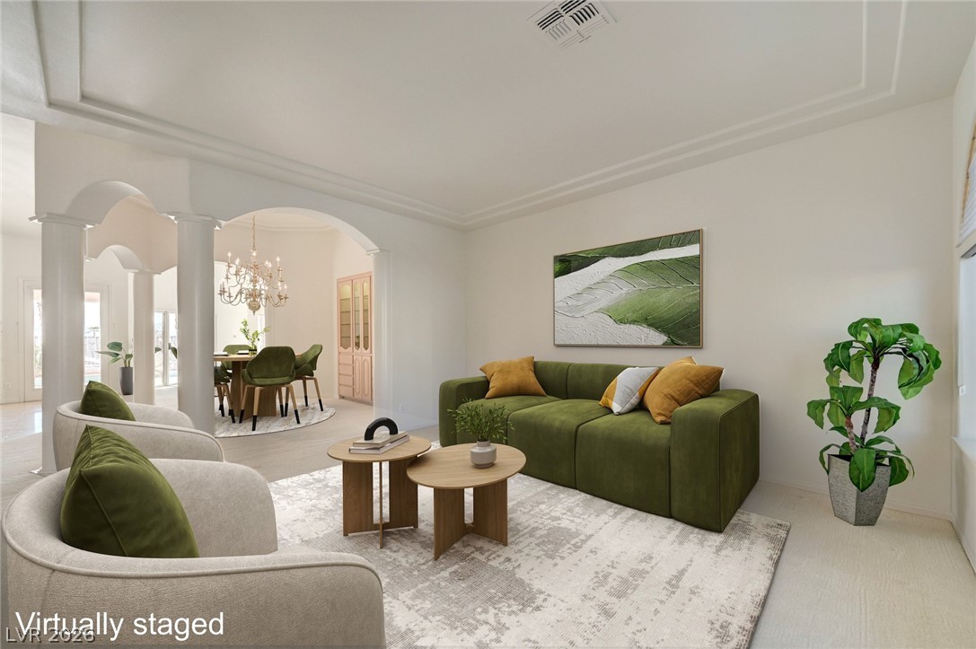 Virtually staged living room with green sofas, cream armchairs, and an arched opening to the dining area.