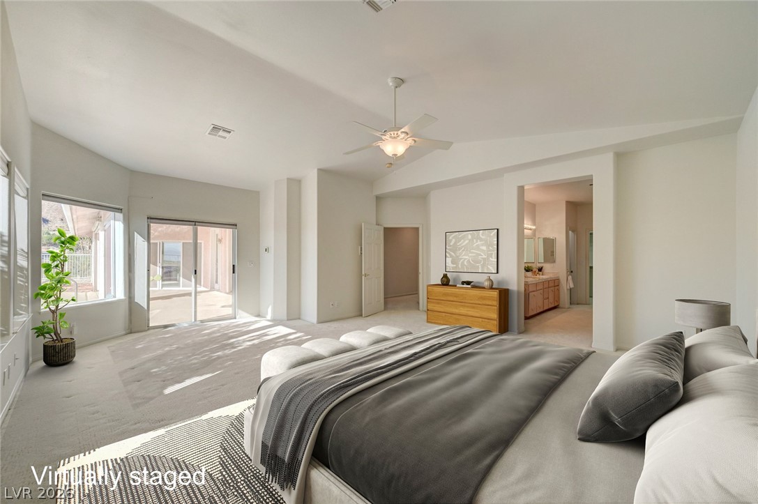 Virtually staged bedroom with a king bed, ceiling fan, and sliding glass doors.