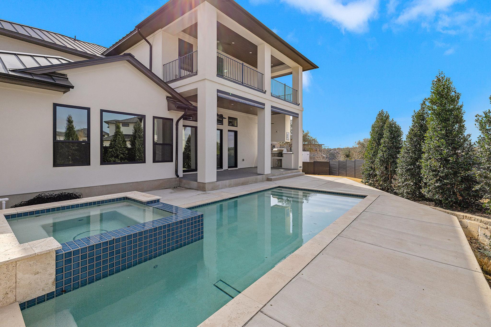 Modern two-story home with a swimming pool and raised spa.