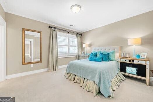 Furnished bedroom with a pale blue bed, turquoise pillows, and a window with white shutters.