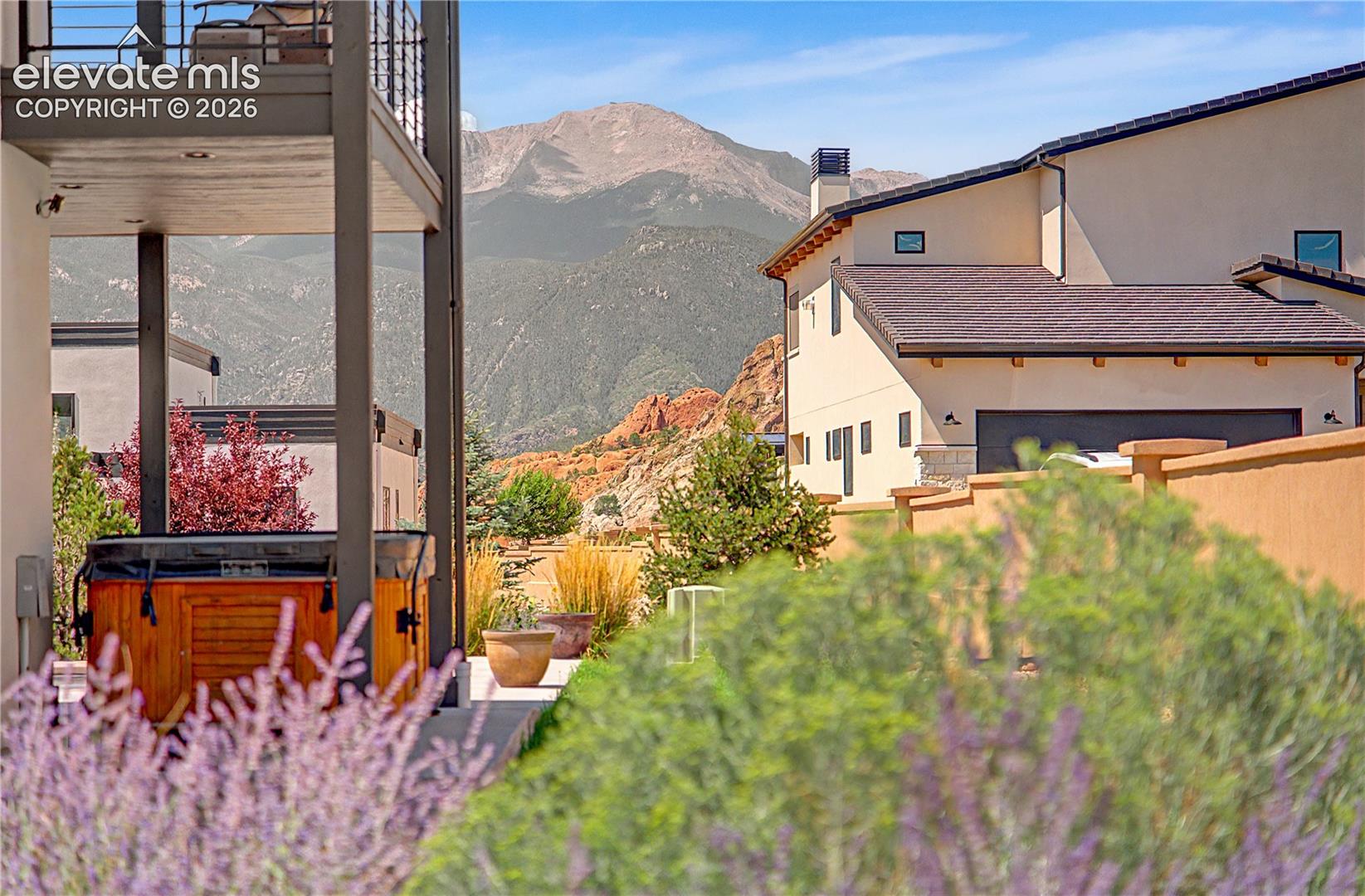 Contemporary homes and a patio hot tub with rugged mountains in the background.