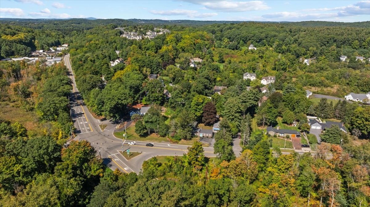 Aerial view of a wooded Southborough neighborhood and road intersection.
