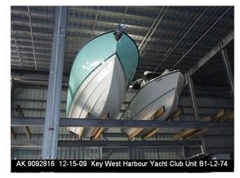 Two boats stored on elevated racks inside a covered boat-storage building.