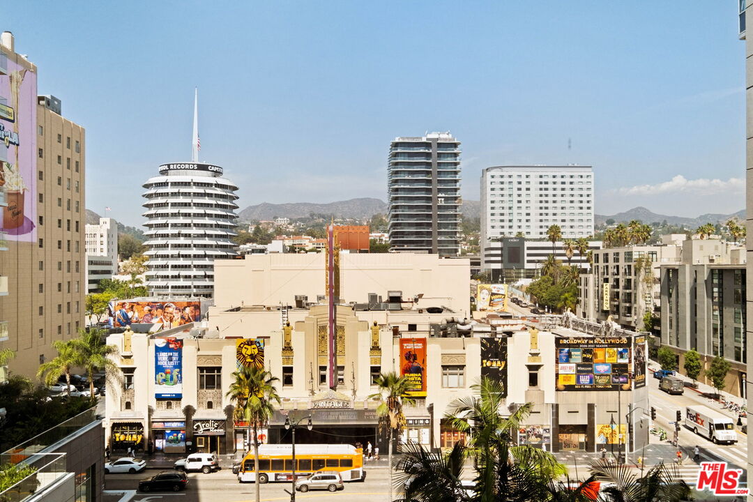 Hollywood city view with the Pantages Theatre, Capitol Records Building, and hills in the distance.