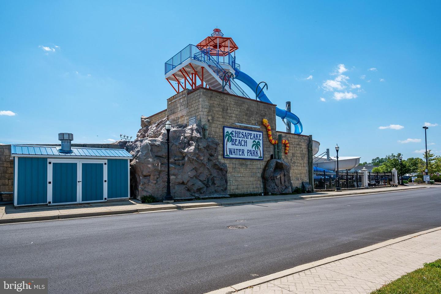 Chesapeake Beach Water Park’s stone tower and blue water slide beside the street.