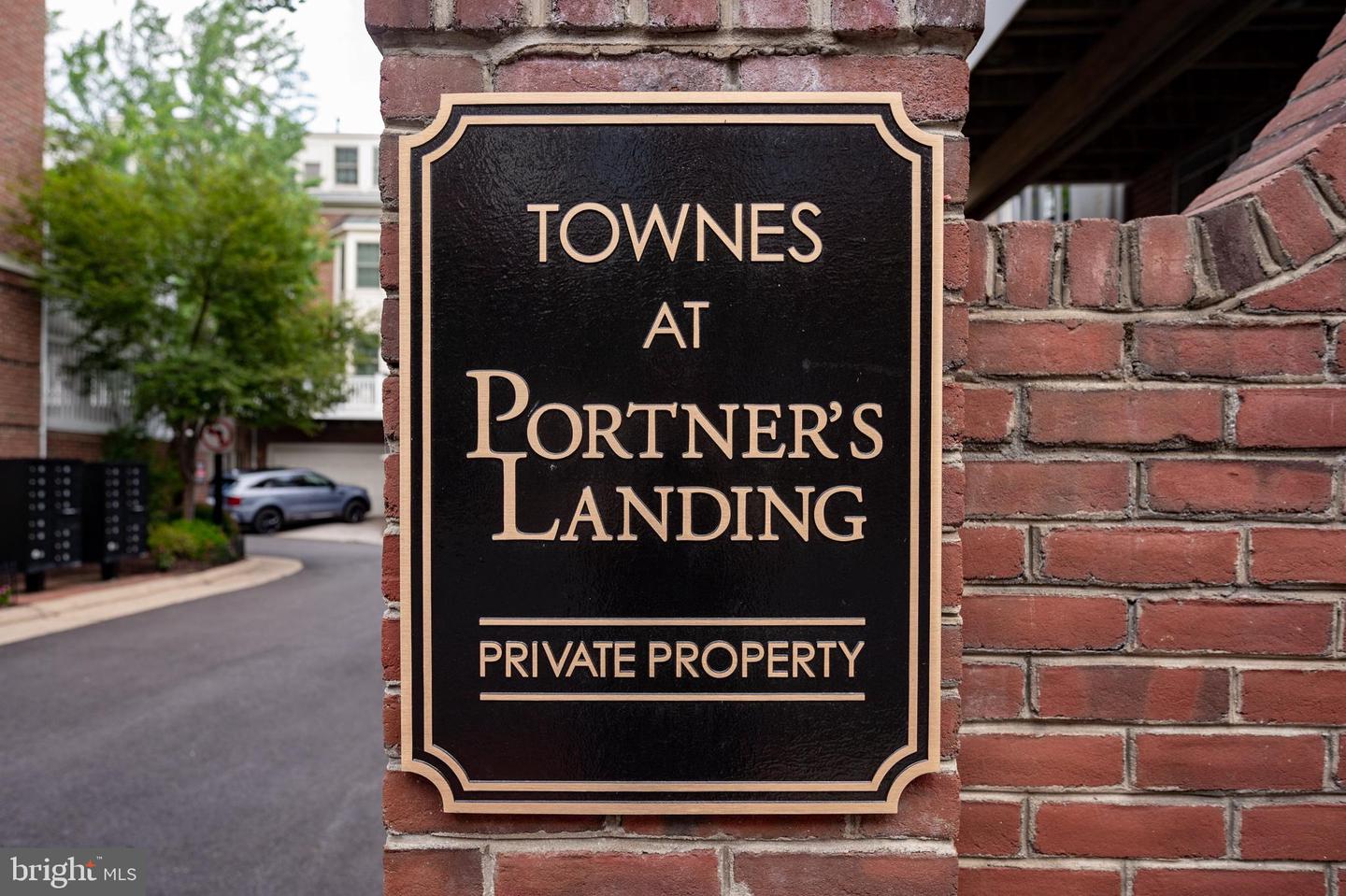 Townes at Portner’s Landing entrance sign mounted on a brick wall.
