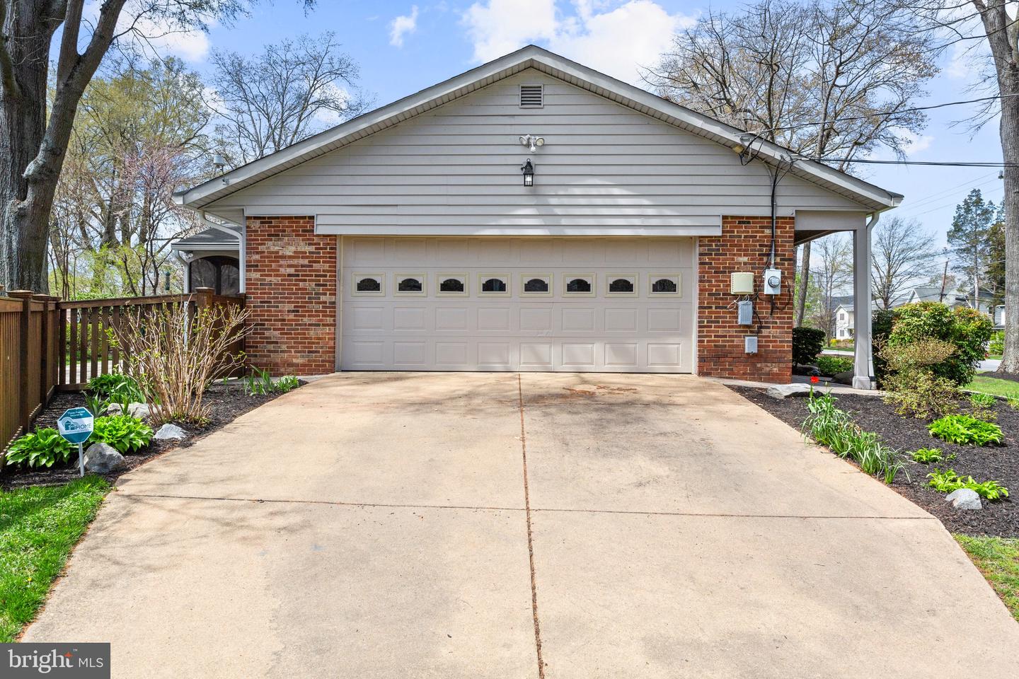Home exterior with a wide driveway leading to an attached double garage.