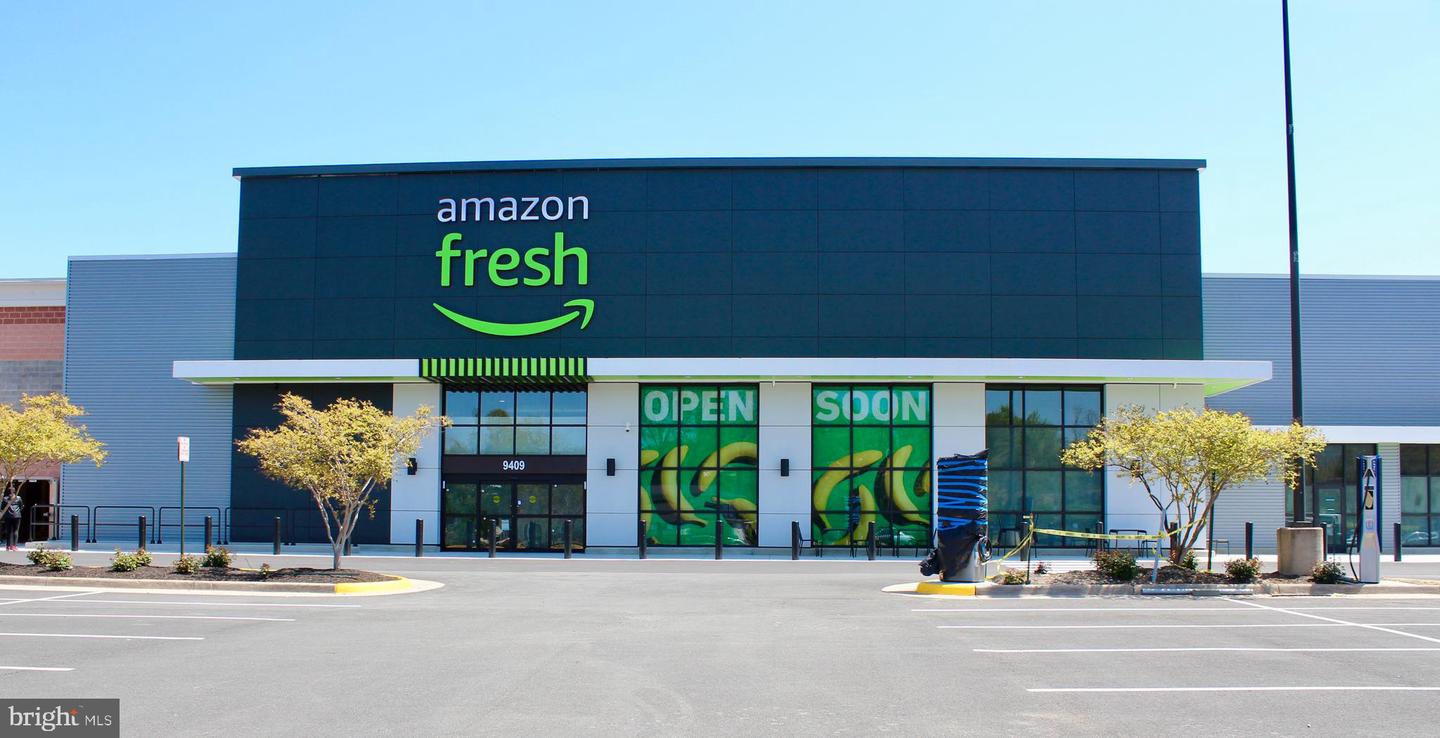 Amazon Fresh storefront with green signage and an empty parking lot.