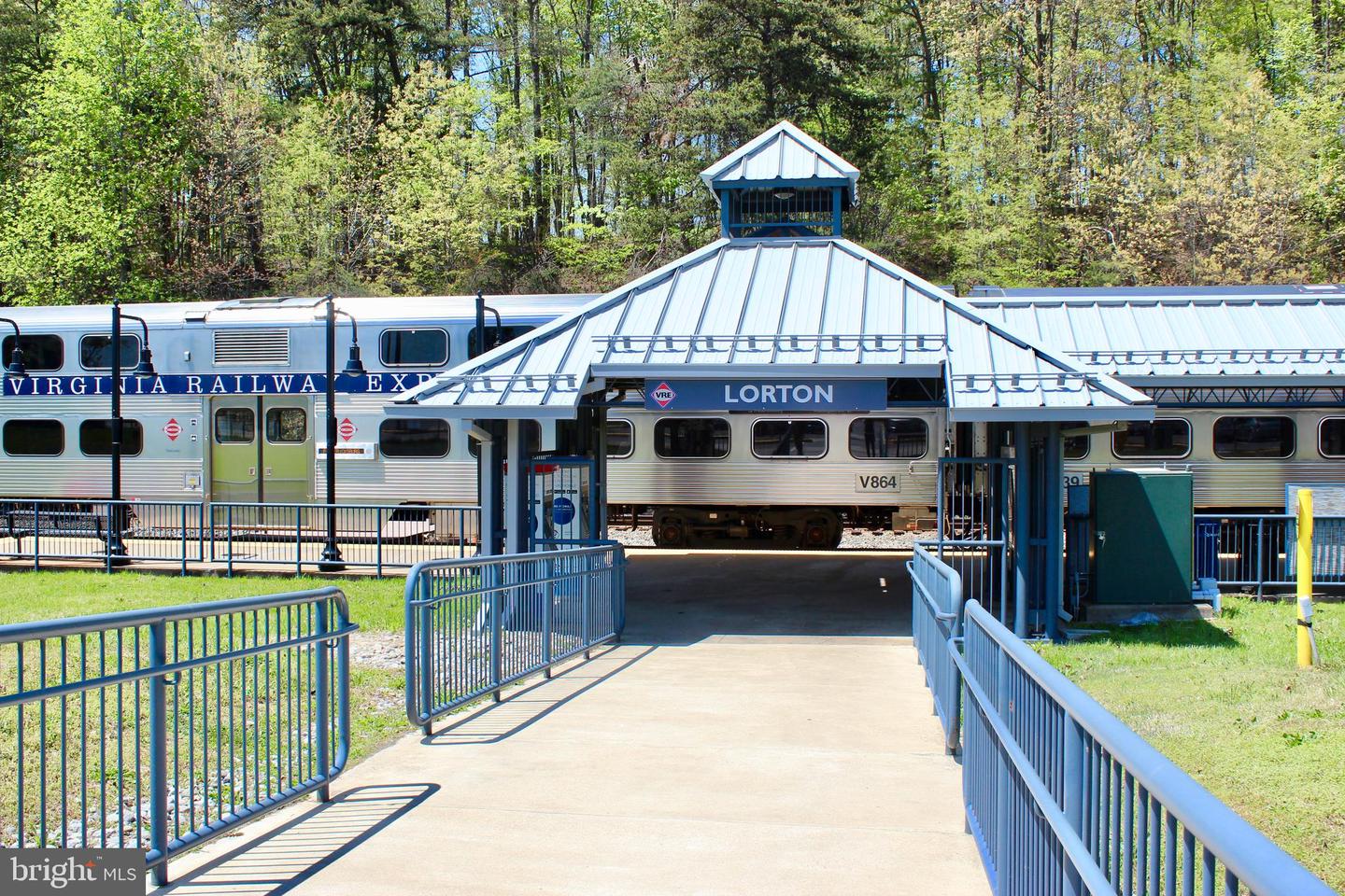 Lorton station with a Virginia Railway Express train behind it and a pedestrian walkway in the foreground.