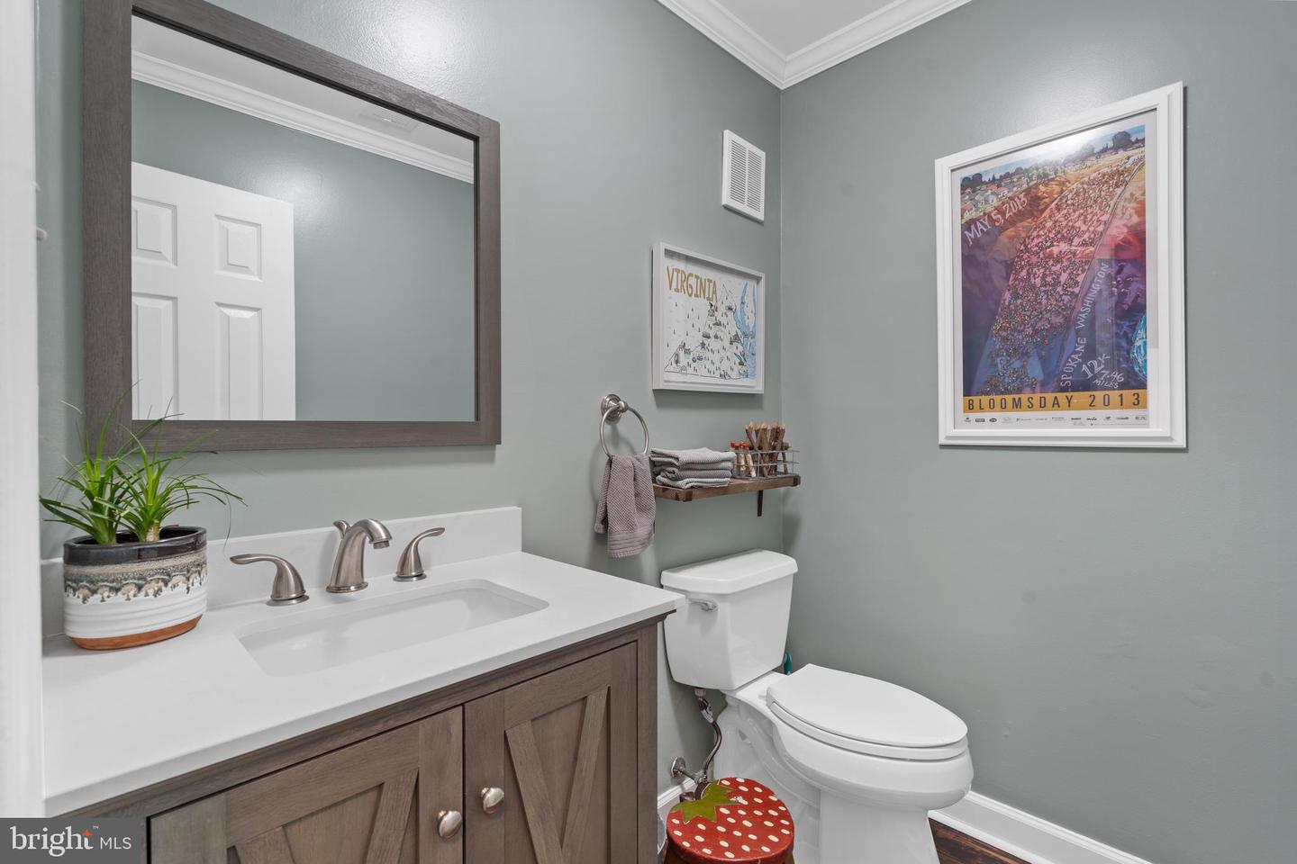 Bathroom with a dark wood vanity, large mirror, and framed Virginia and Bloomsday prints.