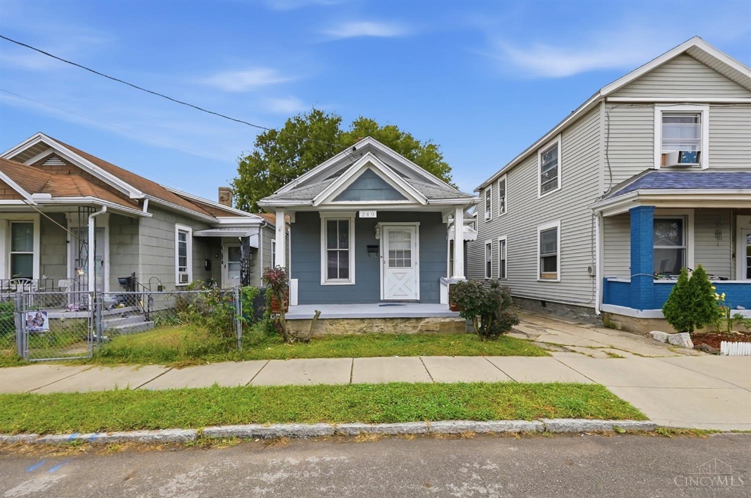 Blue-sided house at 249 Air Street with a covered porch and white trim.