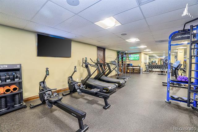 Shared fitness room with treadmills, stationary bikes, and weight equipment.