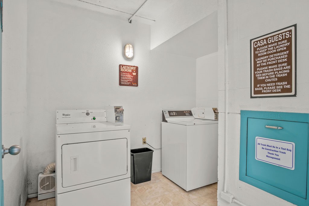 Laundry room with a Whirlpool dryer, top-loading washer, and turquoise trash chute.