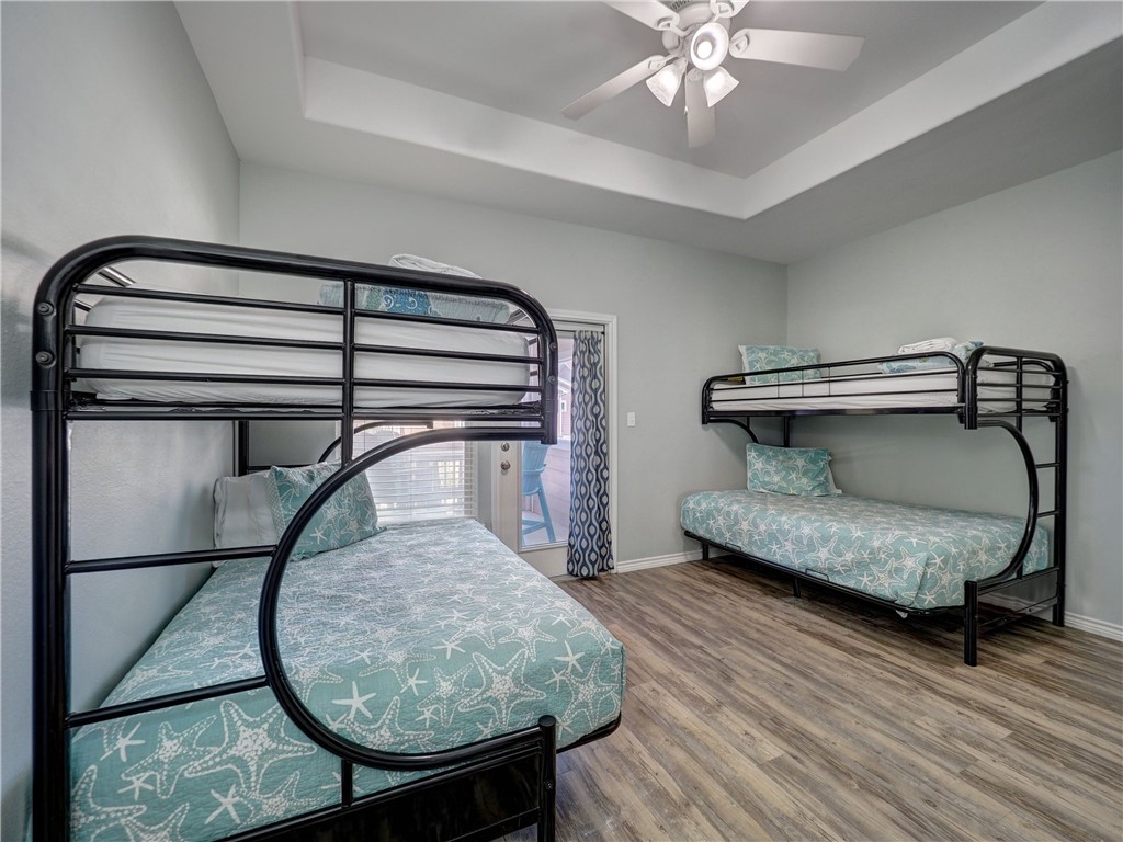 Bedroom with two black metal bunk beds and turquoise starfish-patterned bedding.