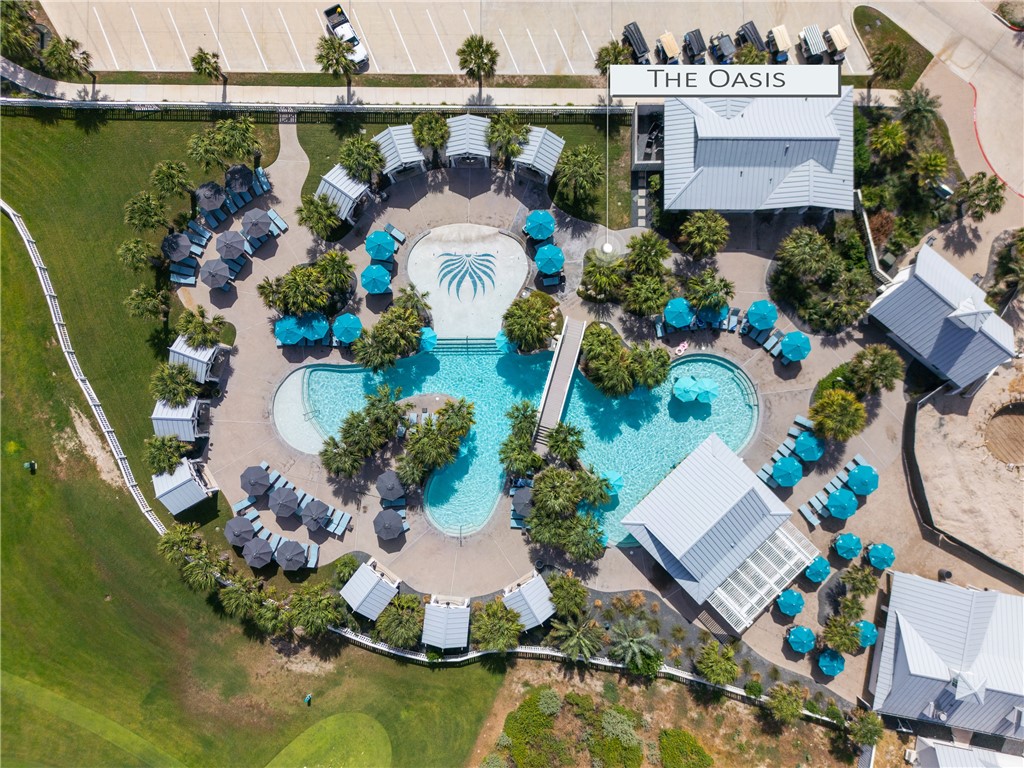 Aerial view of The Oasis pool complex, with two turquoise pools and a circular palm-design feature.