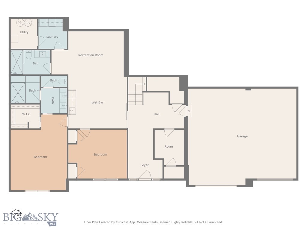 Floor plan with two bedrooms, multiple bathrooms, a recreation room and wet bar, and a large garage.
