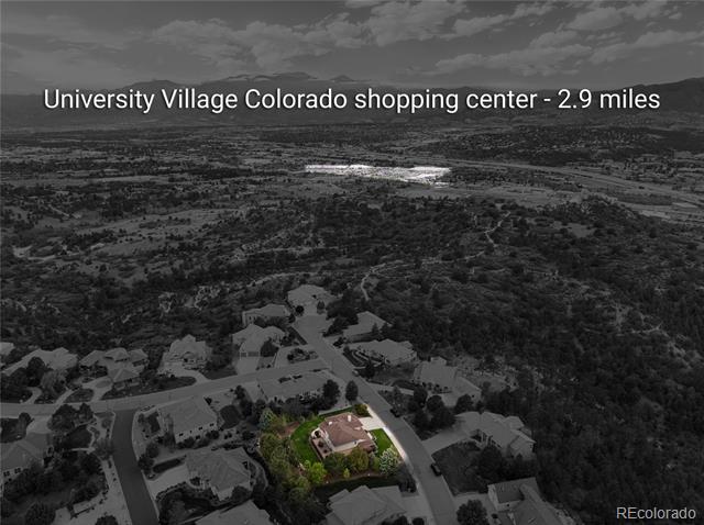Aerial view of a residential neighborhood with one home highlighted in color.