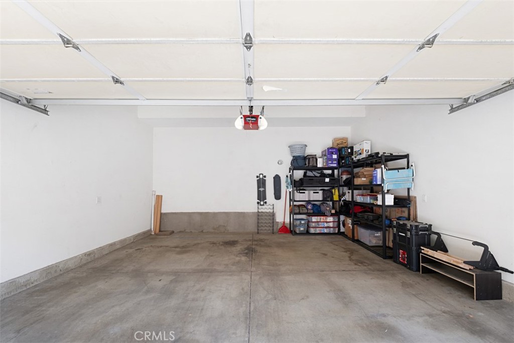 Garage with storage shelves and boxes along the back and right walls.