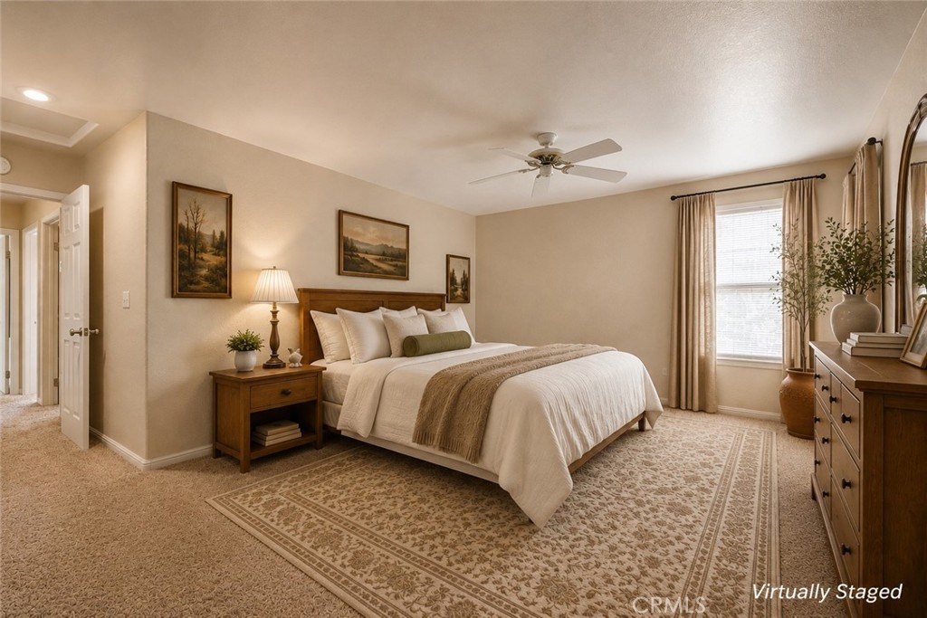 Virtually staged bedroom with cream bedding, wooden furniture, and a patterned area rug.