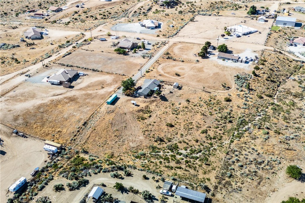 Aerial view of scattered homes and open desert lots along unpaved roads.