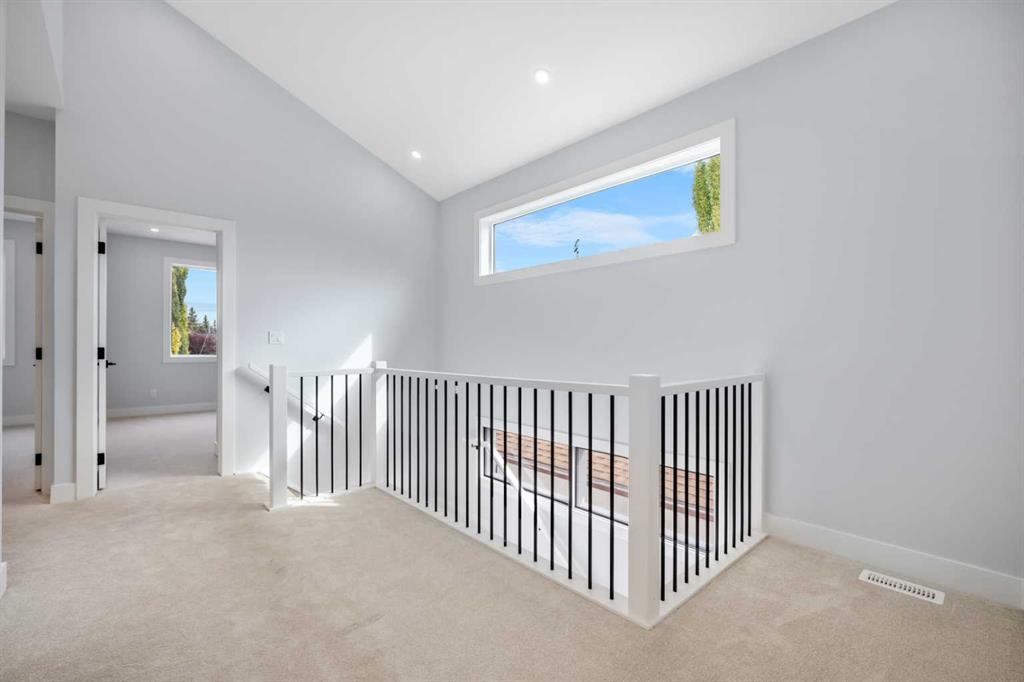 Upper-floor landing with black-and-white stair railing and narrow horizontal window.