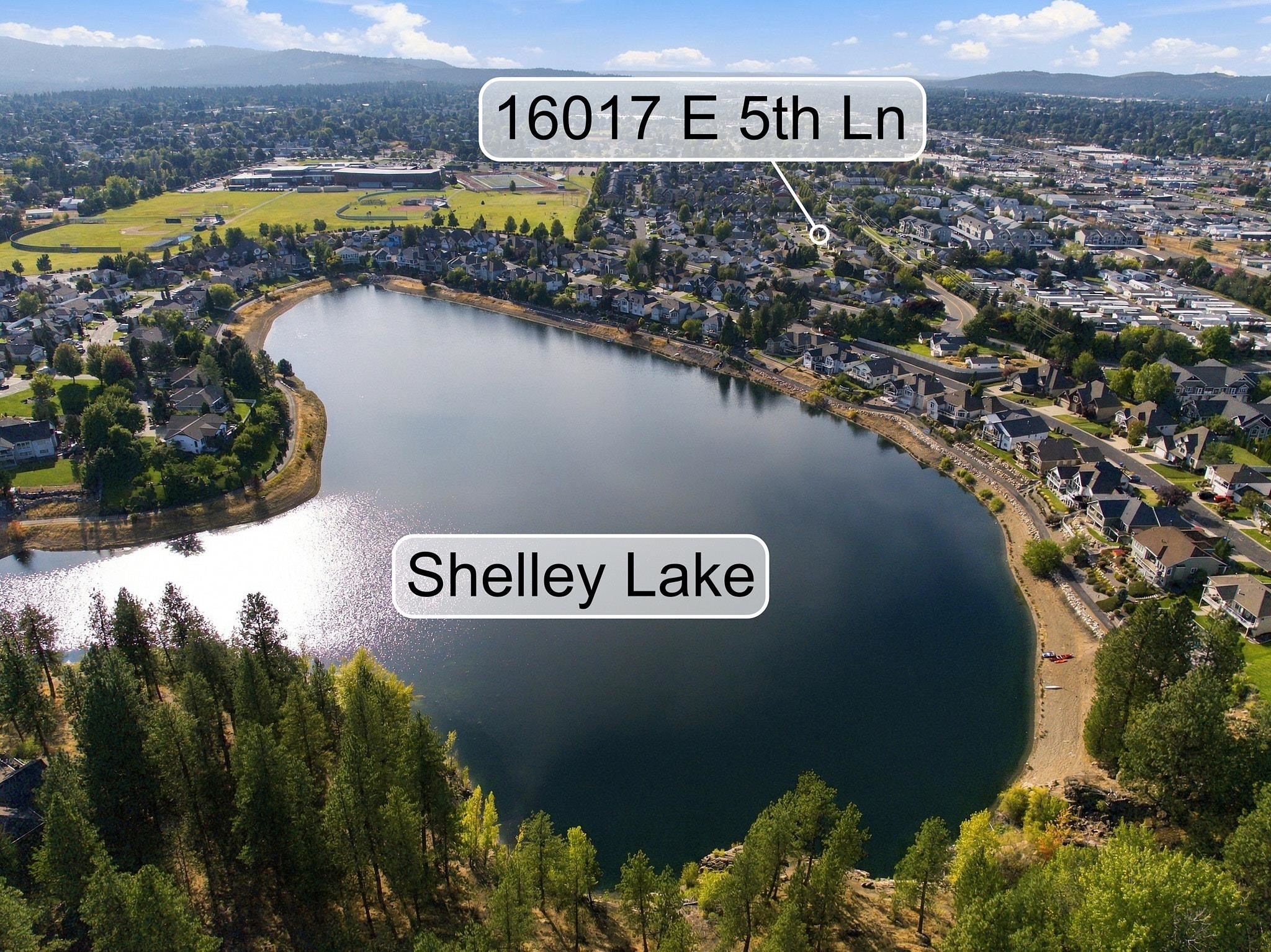 Aerial view of Shelley Lake with surrounding homes and a callout marking 16017 E 5th Ln.