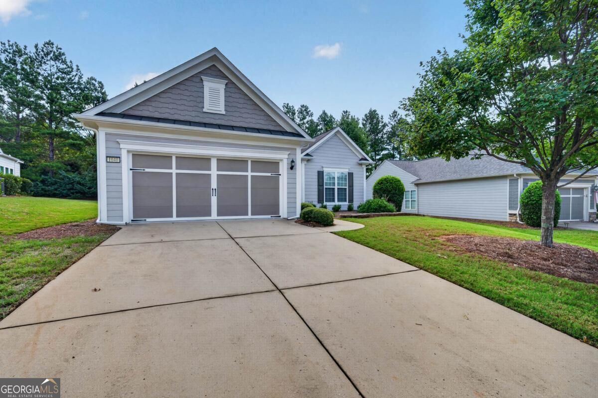 Gray single-story home with a wide two-car garage and concrete driveway.